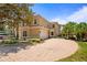 Beautiful two-story home boasts lush landscaping and a circular driveway at 26207 Avenida Las Colinas # 26207, Howey In The Hills, FL 34737
