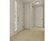 Hallway features neutral ceramic tile flooring, a front door, and a closet door at 26207 Avenida Las Colinas # 26207, Howey In The Hills, FL 34737