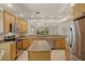 Well-lit kitchen features granite countertops, stainless steel appliances, and an island at 26207 Avenida Las Colinas # 26207, Howey In The Hills, FL 34737