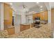 Well-equipped kitchen with granite countertops, tile backsplash, stainless appliances, and light wood cabinets at 26207 Avenida Las Colinas # 26207, Howey In The Hills, FL 34737