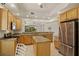 Spacious kitchen features an island, stainless steel appliances, and granite countertops at 26207 Avenida Las Colinas # 26207, Howey In The Hills, FL 34737