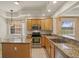 Well-equipped kitchen featuring granite countertops, stainless steel appliances, and wood cabinetry at 26207 Avenida Las Colinas # 26207, Howey In The Hills, FL 34737