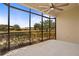 The screened lanai features a ceiling fan and views of the beautiful outdoor landscape at 26207 Avenida Las Colinas # 26207, Howey In The Hills, FL 34737