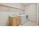 Functional laundry room features a sink, cabinets, and washer/dryer at 26207 Avenida Las Colinas # 26207, Howey In The Hills, FL 34737