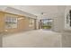 Spacious living room with ample natural light, a modern light fixture, and views of the outdoors at 26207 Avenida Las Colinas # 26207, Howey In The Hills, FL 34737