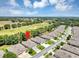 An aerial view shows a home with a view overlooking the golf course and a neighborhood setting at 26951 White Plains Way, Leesburg, FL 34748