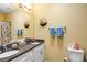 Bathroom featuring double sinks, granite countertops, coastal decor providing a functional and stylish space at 26951 White Plains Way, Leesburg, FL 34748