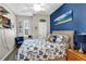 Coastal-themed bedroom with blue accents, starry bedding, and beachy decor creating a relaxing retreat at 26951 White Plains Way, Leesburg, FL 34748