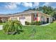 Lovely home with a two-car garage, lush lawn, and well-maintained landscaping with healthy palms at 26951 White Plains Way, Leesburg, FL 34748