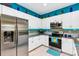 Updated kitchen featuring stainless steel appliances, ample counter space, and modern white cabinets at 26951 White Plains Way, Leesburg, FL 34748