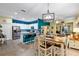 Open-concept kitchen featuring granite countertops, stainless steel appliances, and an eat-in bar top at 26951 White Plains Way, Leesburg, FL 34748