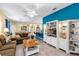 Open-concept living room with sofa, dining area and bar creating a versatile space for relaxation and entertainment at 26951 White Plains Way, Leesburg, FL 34748