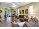 Inviting living room with tile floors, comfortable sofas, and sliding doors leading to the outside at 26951 White Plains Way, Leesburg, FL 34748