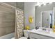 Well-lit bathroom with tub, shower, and a decorative shower curtain at 27018 White Plains Way, Leesburg, FL 34748