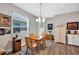 Cozy dining room with wood table, chairs, and modern light fixture at 27018 White Plains Way, Leesburg, FL 34748