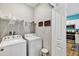 Laundry room with washer, dryer, and a view to the kitchen at 27018 White Plains Way, Leesburg, FL 34748