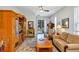 Inviting living room with entertainment center and access to the lanai at 27018 White Plains Way, Leesburg, FL 34748