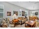 Open concept living room and dining area with comfortable seating at 27018 White Plains Way, Leesburg, FL 34748