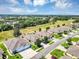 Overhead view of a quiet neighborhood street showcasing well-kept homes and landscaping at 27018 White Plains Way, Leesburg, FL 34748