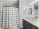 Bathroom with updated vanity and a tub with shower and gray and white decor at 2729 Craven Way, The Villages, FL 32162