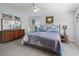 Bedroom with wood look floors, ceiling fan, and dresser and night stands at 2729 Craven Way, The Villages, FL 32162
