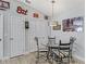 Dining area with seating for four and an interesting light fixture and decor at 2729 Craven Way, The Villages, FL 32162