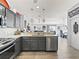 Open kitchen with stainless steel appliances and sight lines to the living room at 2729 Craven Way, The Villages, FL 32162