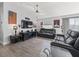 Relax in the living room with comfortable seating, a ceiling fan, and a media center at 2729 Craven Way, The Villages, FL 32162