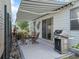 The outdoor patio features a retractable awning, a dining set, and a modern stainless steel grill at 2729 Craven Way, The Villages, FL 32162