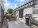 Outdoor patio featuring a retractable awning, dining table with seating, and a stainless steel grill at 2729 Craven Way, The Villages, FL 32162