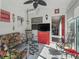 Cozy sunroom with bright white walls, floral furnishings, tile floors, and outdoor views at 2729 Craven Way, The Villages, FL 32162