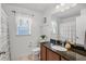 Well lit bathroom with granite counters, tile floors, and a decorative window at 274 Giovani Blvd, Clermont, FL 34715