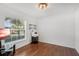 Bedroom with wood flooring, a window for natural light, and wall mounted shelves at 274 Giovani Blvd, Clermont, FL 34715
