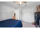 Comfortable carpeted bedroom with a ceiling fan, closet, and view to the main living areas at 274 Giovani Blvd, Clermont, FL 34715