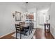 Elegant dining room with hardwood floors, a chandelier, and a view into the kitchen at 274 Giovani Blvd, Clermont, FL 34715