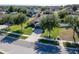 Aerial view of a well-manicured home with a lovely lawn and mature trees in a suburban neighborhood at 274 Giovani Blvd, Clermont, FL 34715