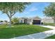 Charming single-story home with a well-manicured lawn, complemented by mature landscaping at 274 Giovani Blvd, Clermont, FL 34715