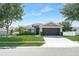 Lovely single-Gathering home featuring a well-maintained lawn, lush landscaping, and a welcoming front entrance at 274 Giovani Blvd, Clermont, FL 34715