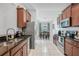 Well-lit kitchen with stainless steel appliances, granite countertops, and tile flooring at 274 Giovani Blvd, Clermont, FL 34715