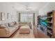 Inviting living room featuring a plush sectional sofa, wood floors, and sliding glass doors at 274 Giovani Blvd, Clermont, FL 34715