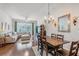Open-concept living room and dining room features hardwood floors and modern lighting at 274 Giovani Blvd, Clermont, FL 34715