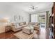 Comfortable living room with a large sectional sofa, wood floors, and a view of the backyard at 274 Giovani Blvd, Clermont, FL 34715