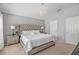 This is a spacious main bedroom featuring a large window, chandelier, and neutral decor and carpet at 274 Giovani Blvd, Clermont, FL 34715