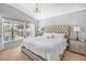 Spacious main bedroom featuring a large window, chandelier, and neutral decor and carpet at 274 Giovani Blvd, Clermont, FL 34715