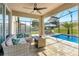 An enclosed patio offers an outdoor lounge area next to a pristine pool at 274 Giovani Blvd, Clermont, FL 34715