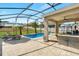 A covered patio features an outdoor lounge and dining area with views of the screened-in pool at 274 Giovani Blvd, Clermont, FL 34715