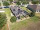 Aerial view of a screened-in pool area, complete with solar panels, and a well-maintained backyard at 274 Giovani Blvd, Clermont, FL 34715