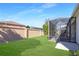 Fenced backyard featuring a well-maintained lawn and screened-in patio, offering privacy and relaxation at 287 Ellenton Run, The Villages, FL 32162