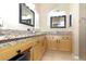 Bathroom features granite countertops, double sinks, and wood cabinets at 287 Ellenton Run, The Villages, FL 32162