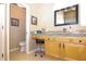 Bathroom features a granite countertop, wood cabinets, and tile flooring at 287 Ellenton Run, The Villages, FL 32162
